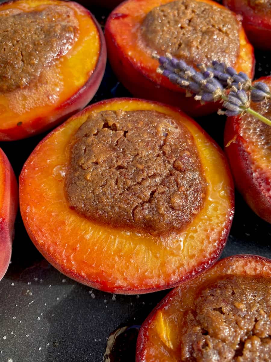 hairy-raspberry-bush close up of a few baked peaches just out of the oven, stuffed with a toasted almond filling
