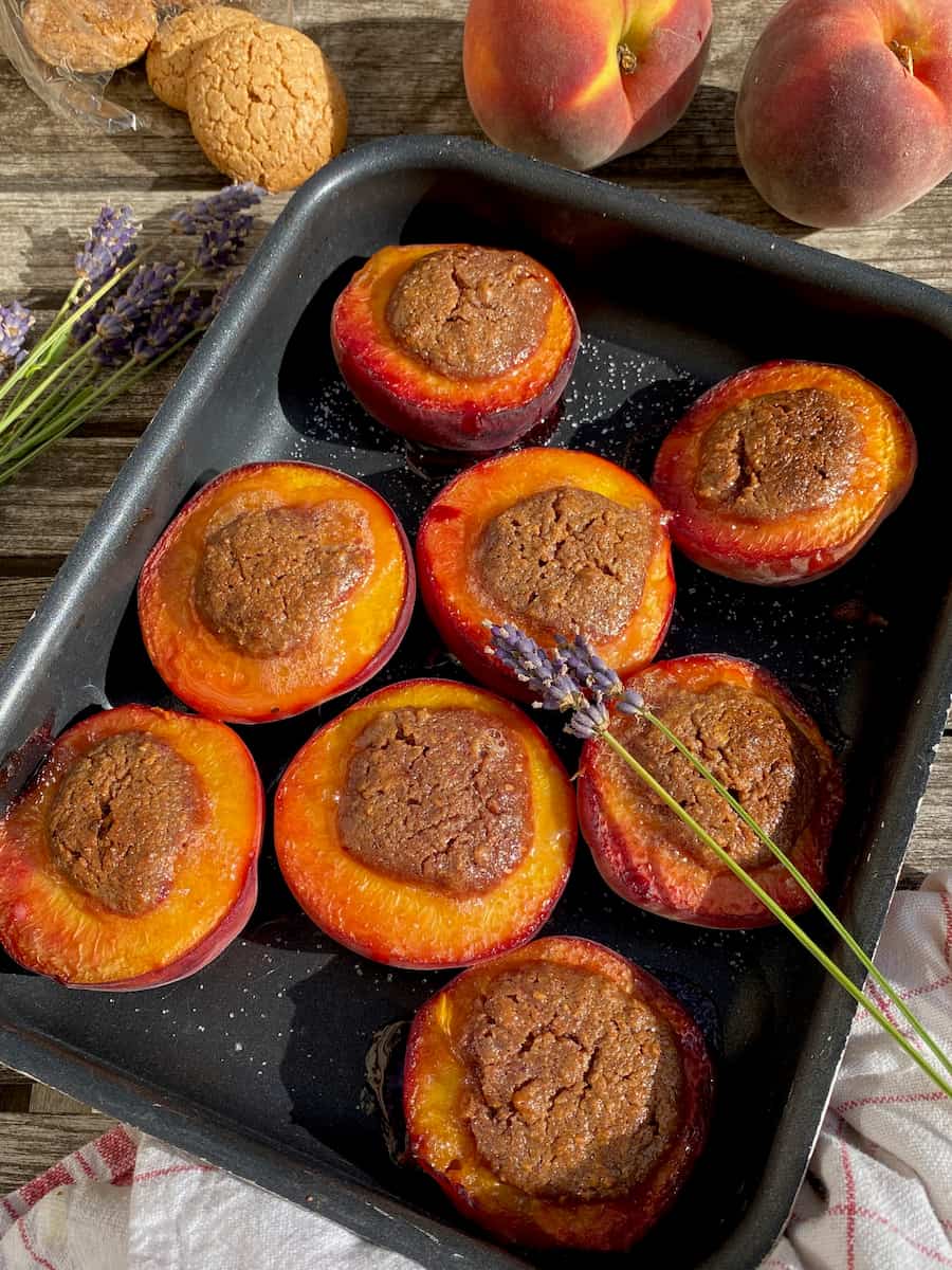 honey-baked-raspberry-peaches baked peach halves stuffed with almond filling and topped with lavender flowers