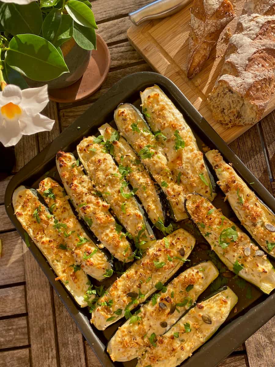 Garden-mint baked zucchini boats filled with cheese, herbs, nuts and seeds