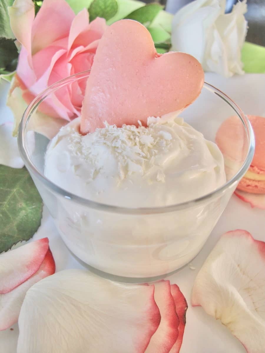 white-chocolate-rose-mousse-macaron glass dish of white chocolate mousse garnished with chocolate shavings and a rose heart macaron shell