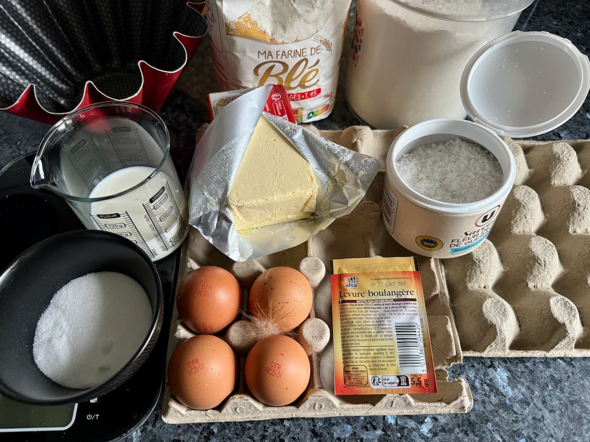 brioche-dough-rising-double ingredients laid out to make a French brioche: flour, eggs, butter, sugar, yeast and salt
