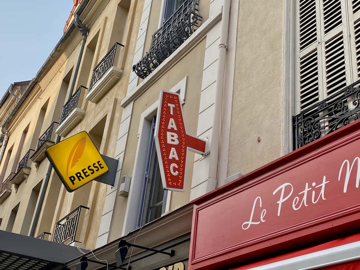 Tabac sign in France, bright red in a lozange shape to indicate a tobacconist